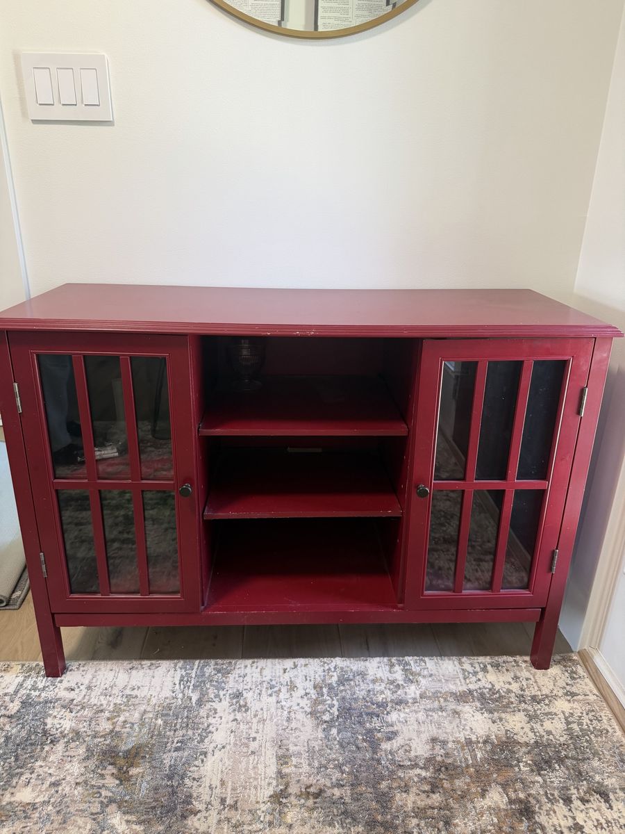 Red media console with glass doors 