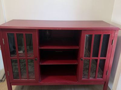 Red media console with glass doors