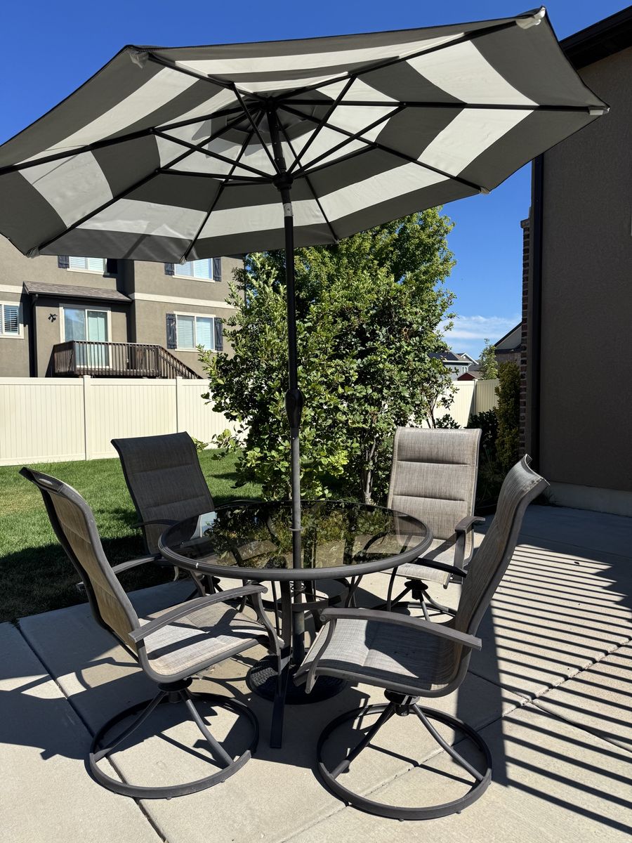 Outdoor Patio Dining Set with Umbrella - Glass Table & 4 Swivel Chairs, Black and White Stripe Umbrella