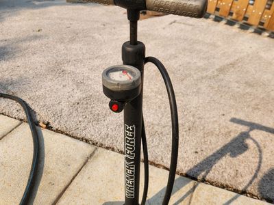 Bike pump with pressure gauge, has both Presta and Shrader fittings. Works great.