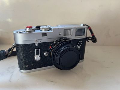 Leica M4 camera with a 35mm Summicron IV lens—a film camera and lens.