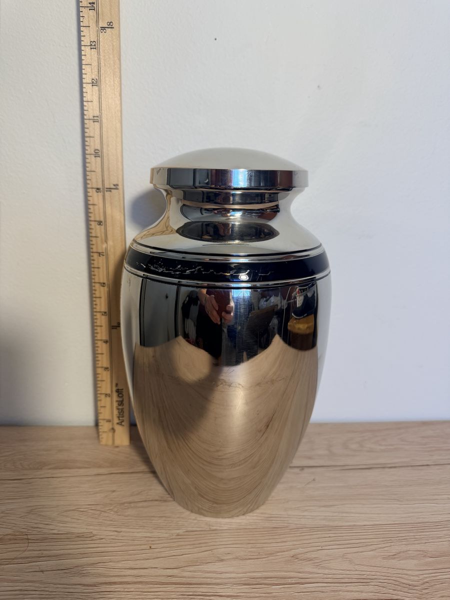 Silver metal urn with black band 10”