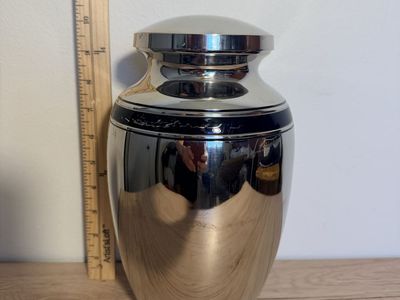 Silver metal urn with black band 10”