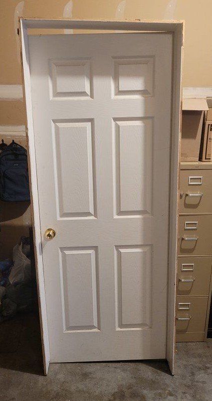6-Panel Wooden Door with Brass Knob and Paneled Trim