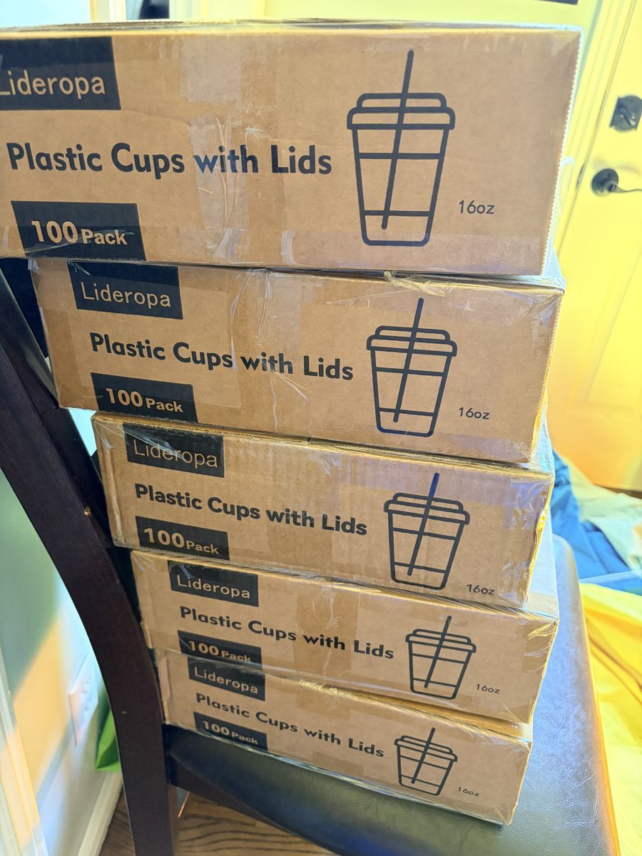 new, unopened plastic cups with lids and straws