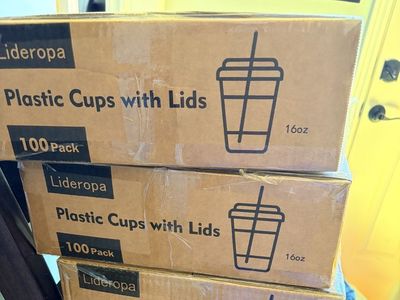 new, unopened plastic cups with lids and straws