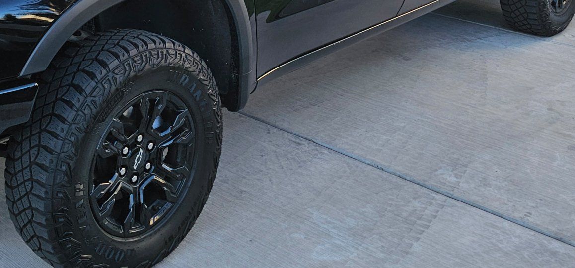 Goodyear Wrangler Territory AT LT275/70R18 All-Terrain Tires & Black Chevrolet Rims