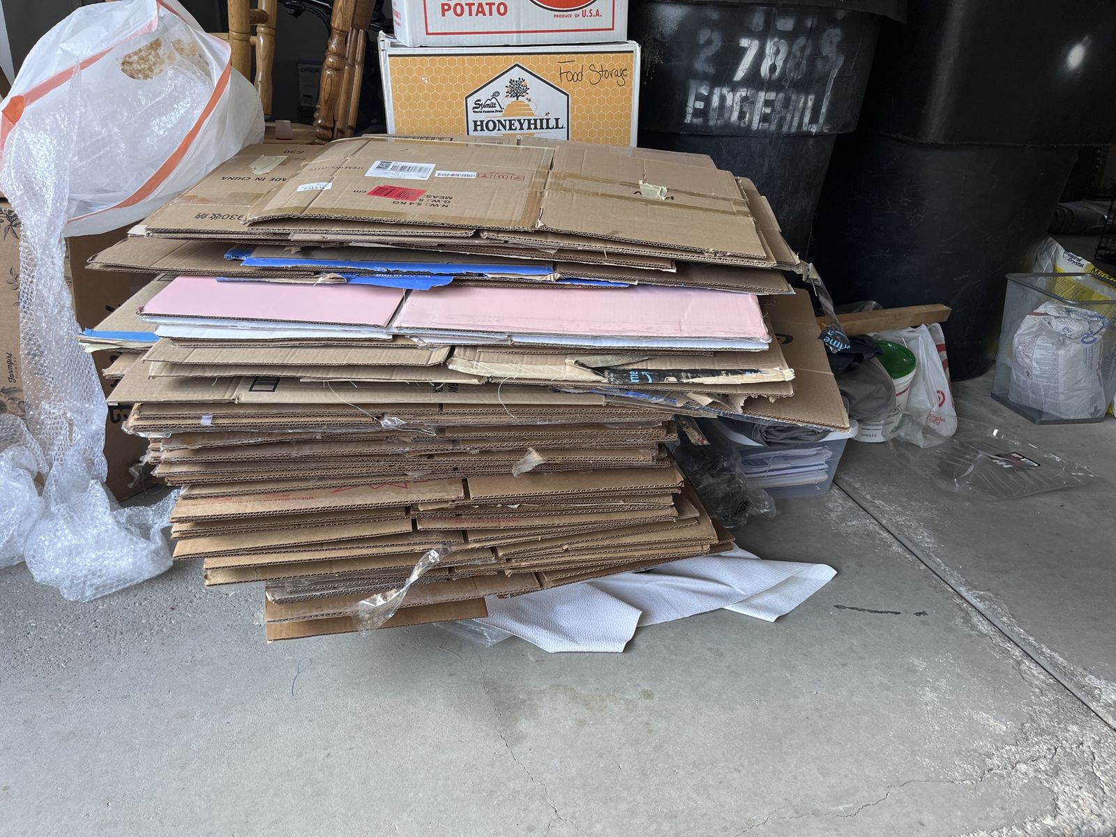 Assorted Used Cardboard Boxes and Flattened Cartons for Moving and Storage