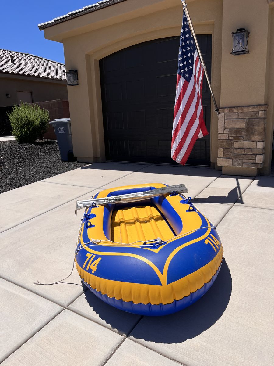 1 two person inflatable boat with 2 paddles plus 2 similar one person inflatable boats.
