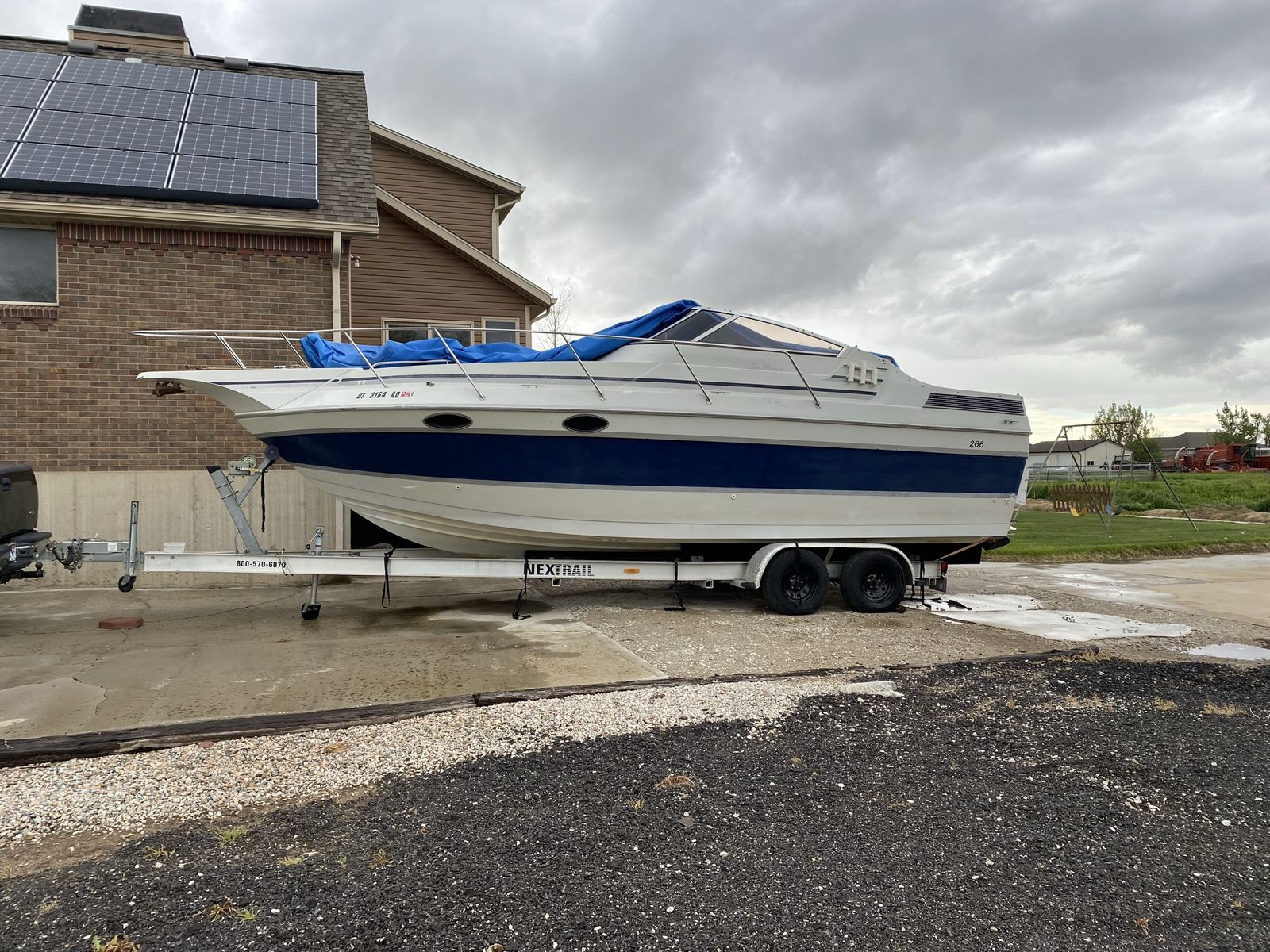 26 ft. Boat with Trailer - 'Only Child' Named Vessel, White & Blue Hull, Ready for the Water