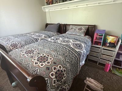 2 twin size Wooden Sleigh Bed Frames with Detailed Headboards and Footboards