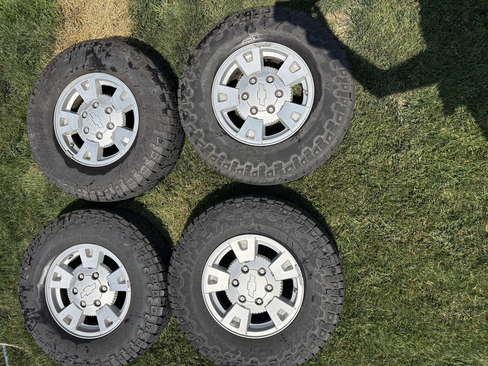 Set of 4 Chevy 15" Alloy Wheels with Hercules Terra Trac A/T Tires (30x9.50R15LT)