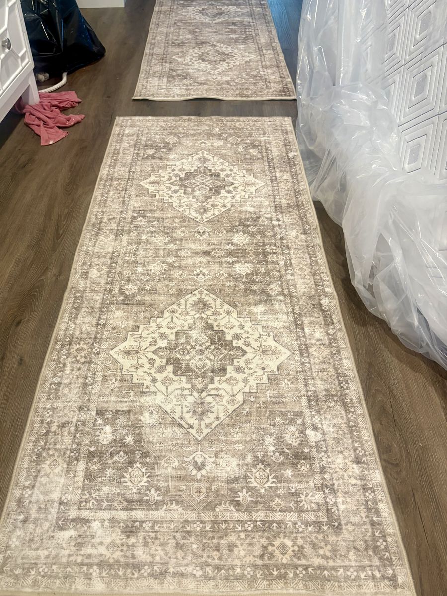 Two brand new runner rugs that are machine washable