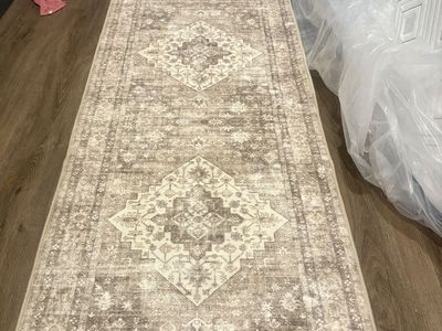 Two brand new runner rugs that are machine washable