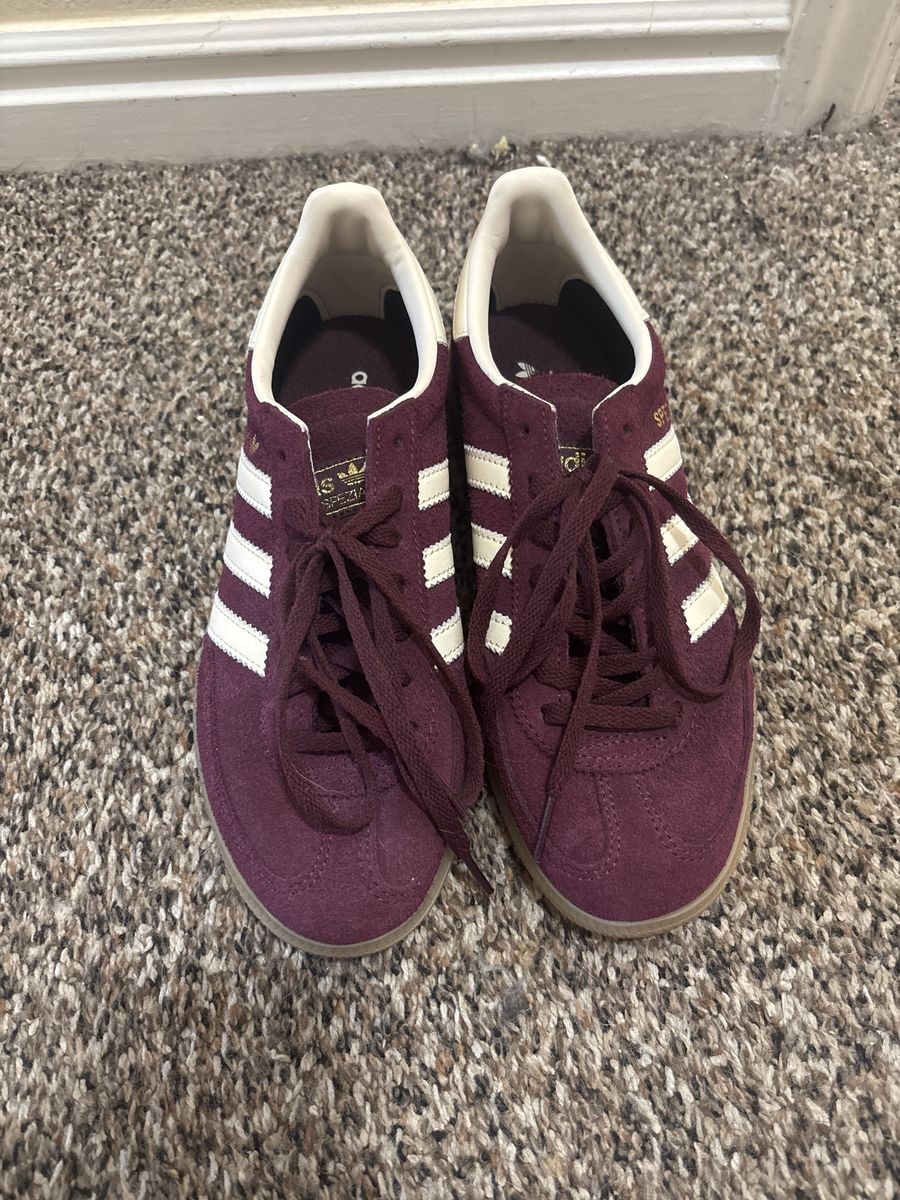 Adidas Handball Spezial in a maroon suede colorway with white stripes woman’s 6.5