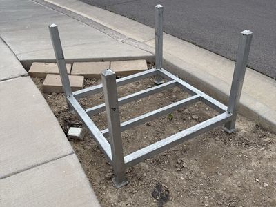 Two metal pallets and two large wooden pallets