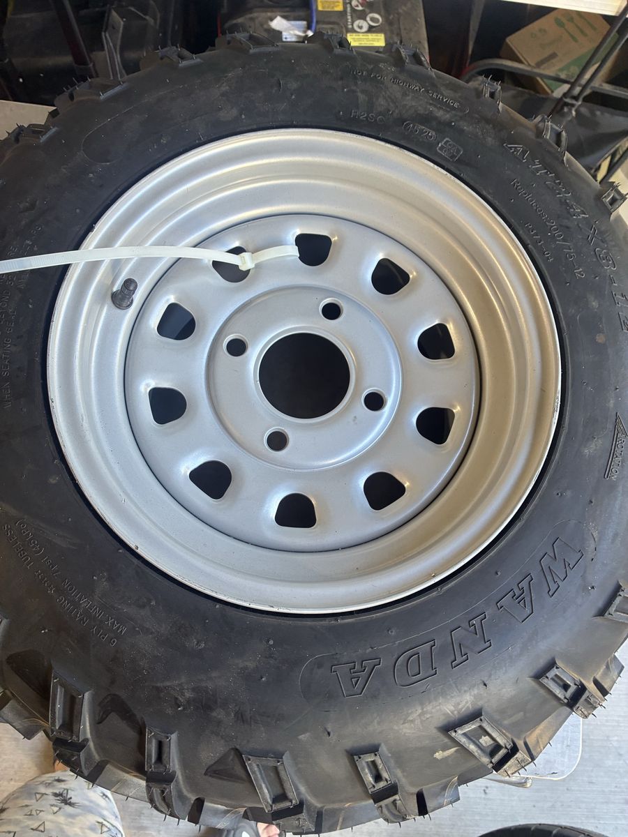 Wanda AT 24x8-12 ATV UTV tire on grey 4 lug wheel.  Both new.