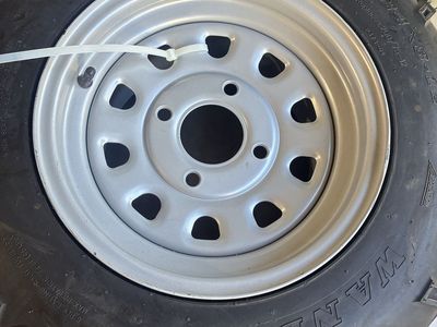 Wanda AT 24x8-12 ATV UTV tire on grey 4 lug wheel. Both new.