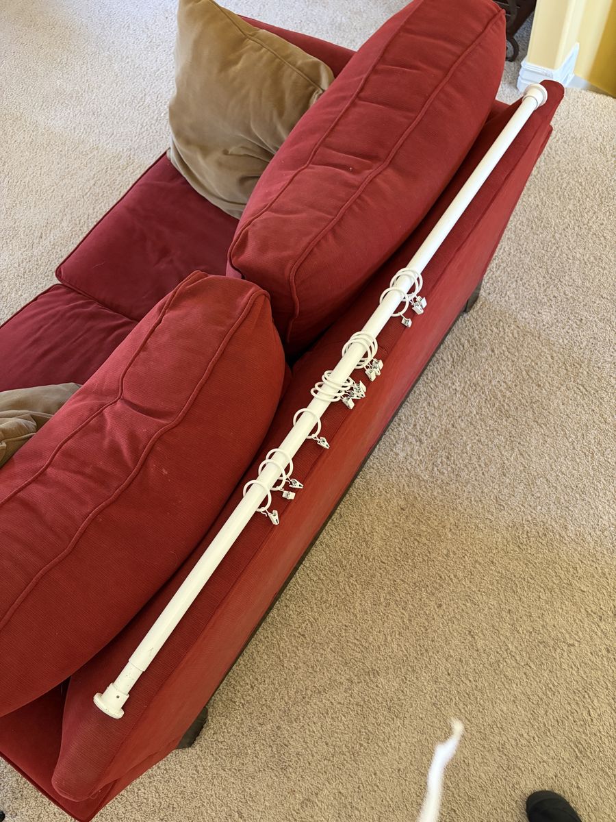 White metal curtain rod with metal clips
