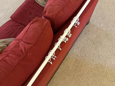 White metal curtain rod with metal clips