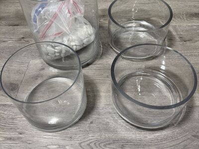 Glass planters and white stones