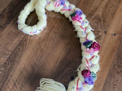 Kids sized homemade Rapunzel yarn braid with flowers