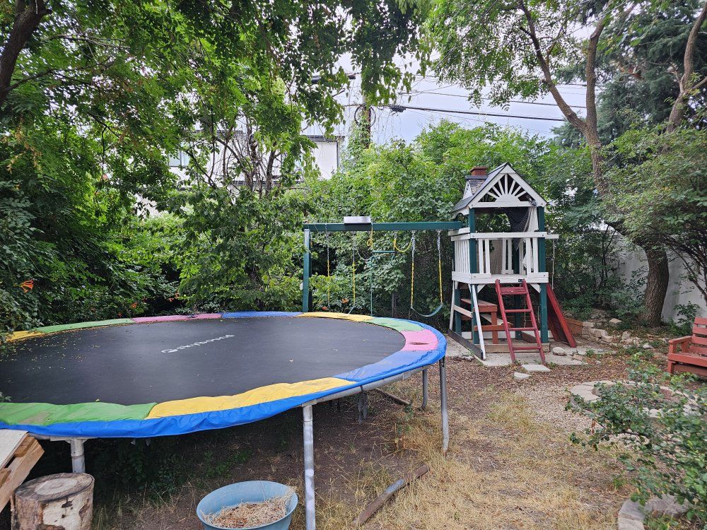 SkyBound 14ft Round Trampoline - Used, with colorful spring pad