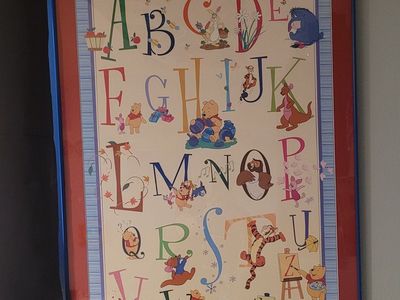 Winnie the Pooh poster and stuffed animals