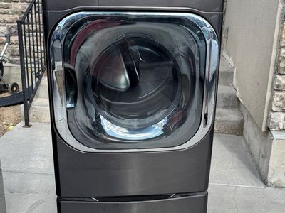 LG ThinQ Washer and Dryer Set in Black Stainless Steel with Pedestals