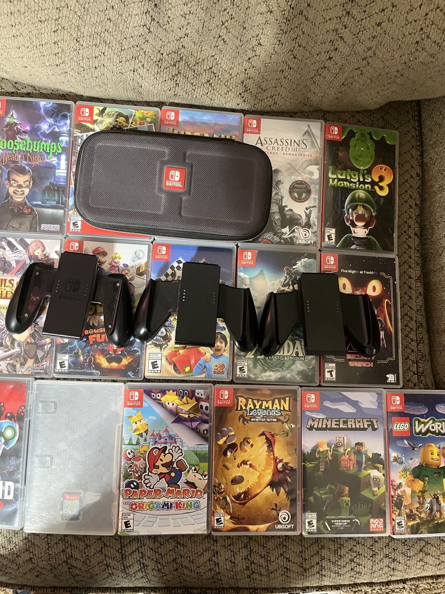 Switch games and controllers for joy cons and a switch case. Yoshis crafted world is the game without and art cover