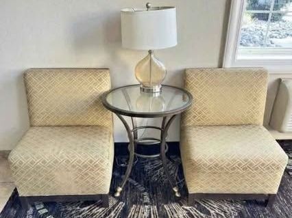Two chairs with table and lamp
