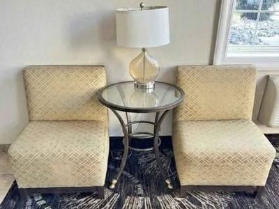 Two chairs with table and lamp