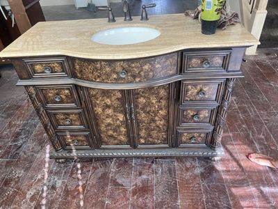 Ornate Dark Wood Bathroom Vanity with Marble Top and Multiple Drawers