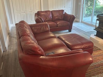Three piece Red Leather Living Room Set. (Couch, Ottoman and Love Seat