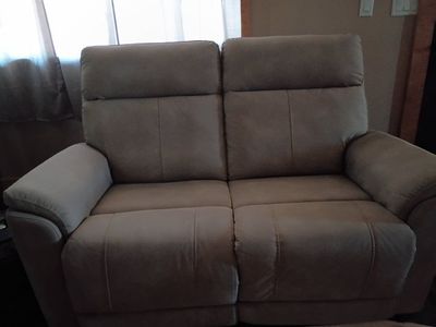 Beige Fabric Power Reclining Loveseat with Built-In Controls . Bought in May this year.