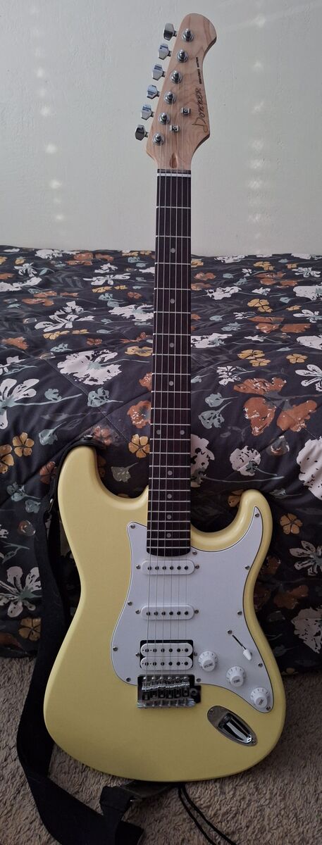 Brand new pretty yellow Donner Electric Guitar with storage/carry bag, amp and other accessories.