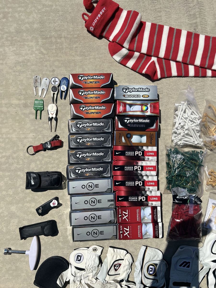 Assorted golf supplies and new golf balls