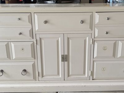 Cream colored dresser and nightstand