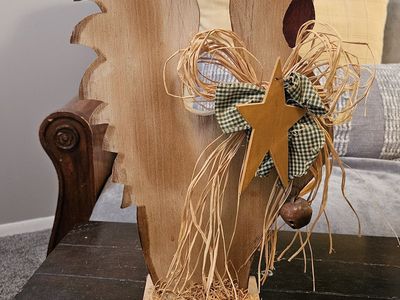 Wood decorative rooster with star, bells, and bow.
