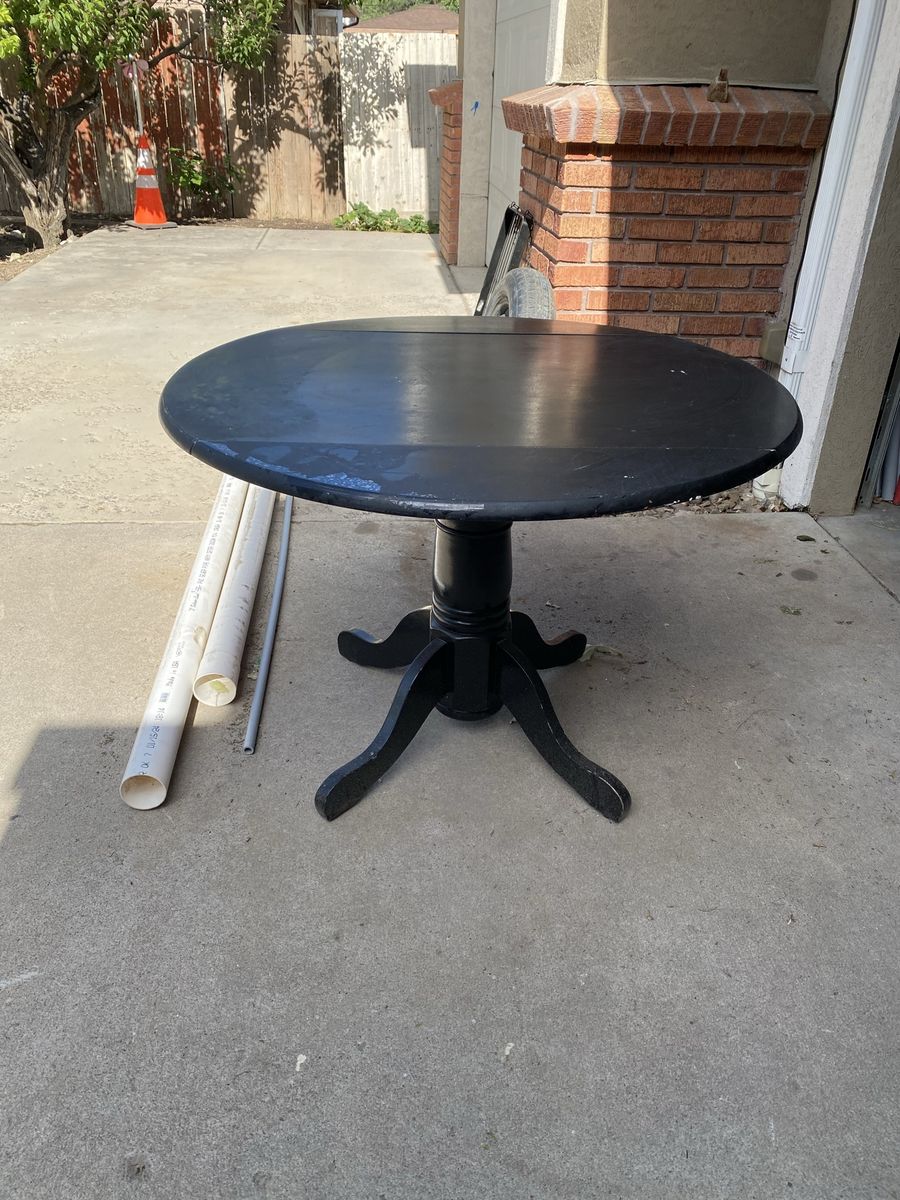 Black Round Pedestal Dining Table - comes with two matching black chairs..
