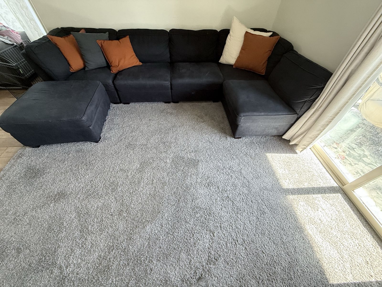Large Dark Blue Sectional Sofa with Ottoman and Accent Pillows