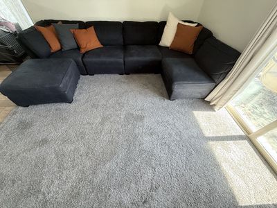 Large Dark Blue Sectional Sofa with Ottoman and Accent Pillows