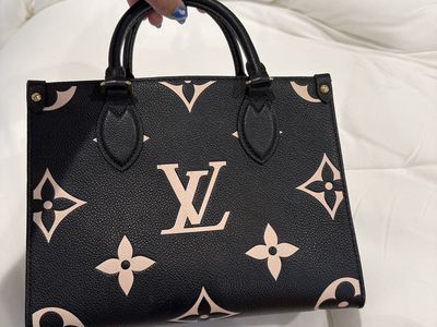 Louis Vuitton on the go mini, black-and-white embossed.