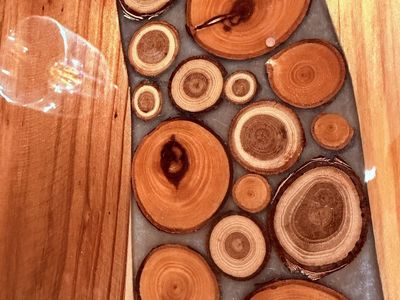 Handmade Live Edge Wood Resin Coffee Table with Inlaid Wood Slices and two matching end tables.