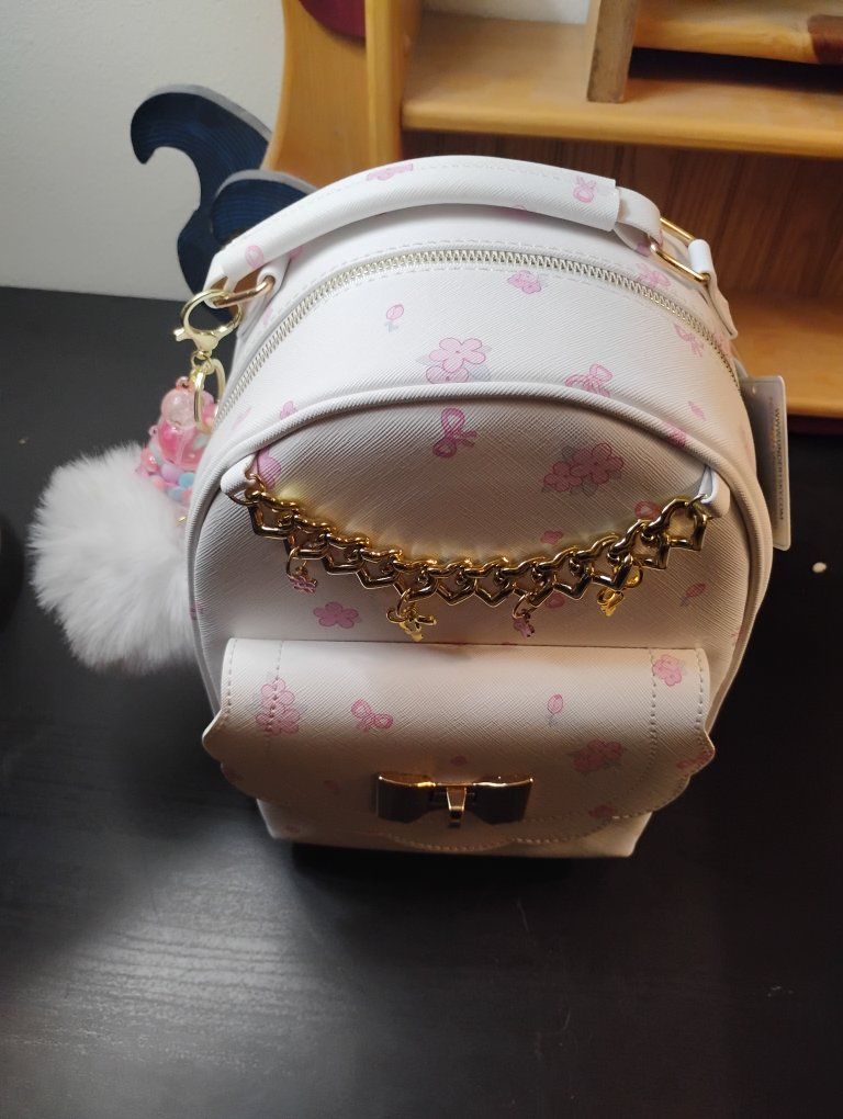 UNDERONESKY White Mini Backpack with Pink Cherry Blossom & Ribbon Print, Gold Chain Detail, & Pom Charm