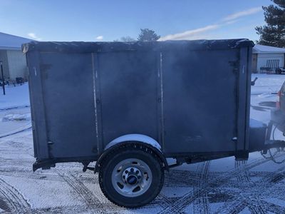 Enclosed 4’ x 8’ trailer.