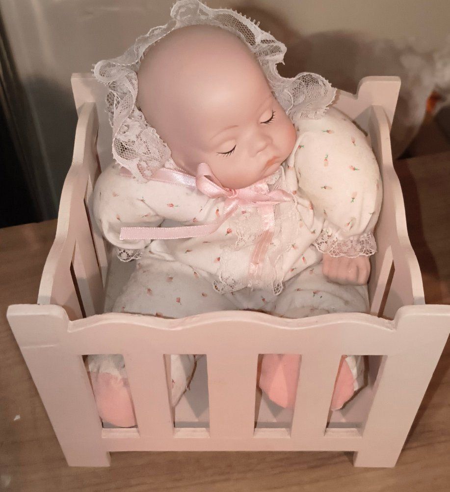 Porcelain Sleeping Baby Doll in Pink Wooden Crib Musical Box