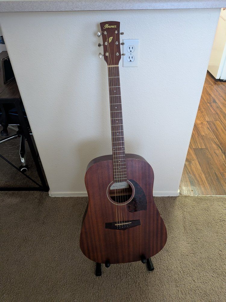 Acoustic guitar with stand