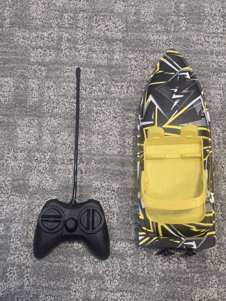 Yellow and Black Remote Control Boat with Controller - Ready for Water Fun!
