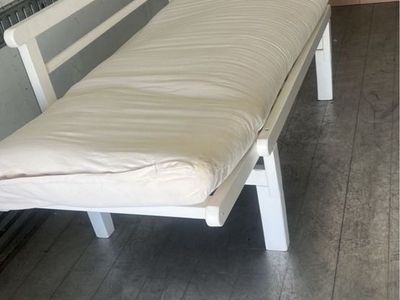 White Wood Frame Daybed with Cream Cushion it has some spots on it but it has a new cover then you can see the spots